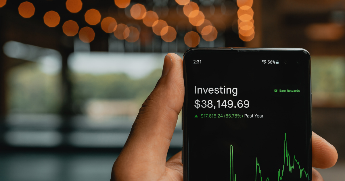 Image of a mobile phone with the screen showing an investing app.